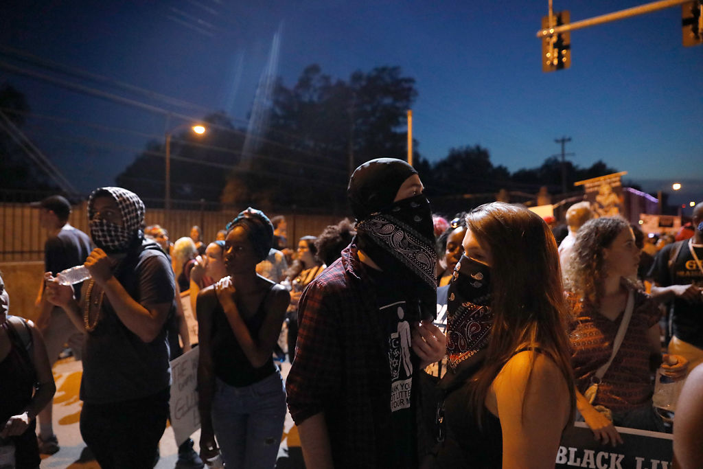 Protestors look for a way out of a highway intersection after a brief scare
